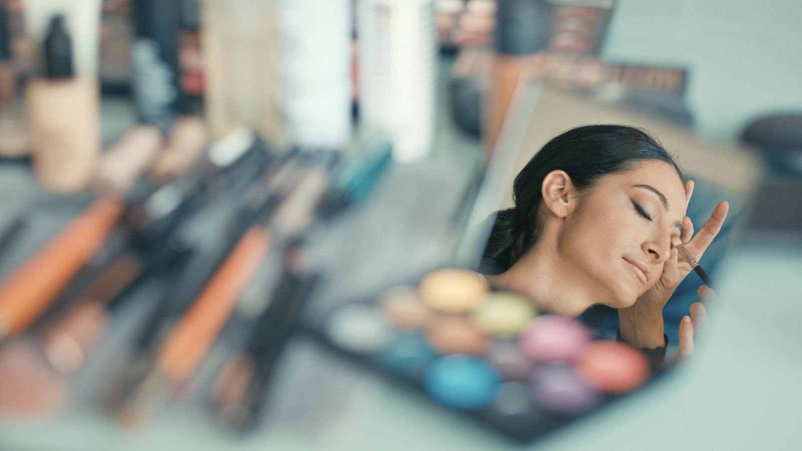 The bride enjoys a calm makeup session on her wedding morning in Florida.
