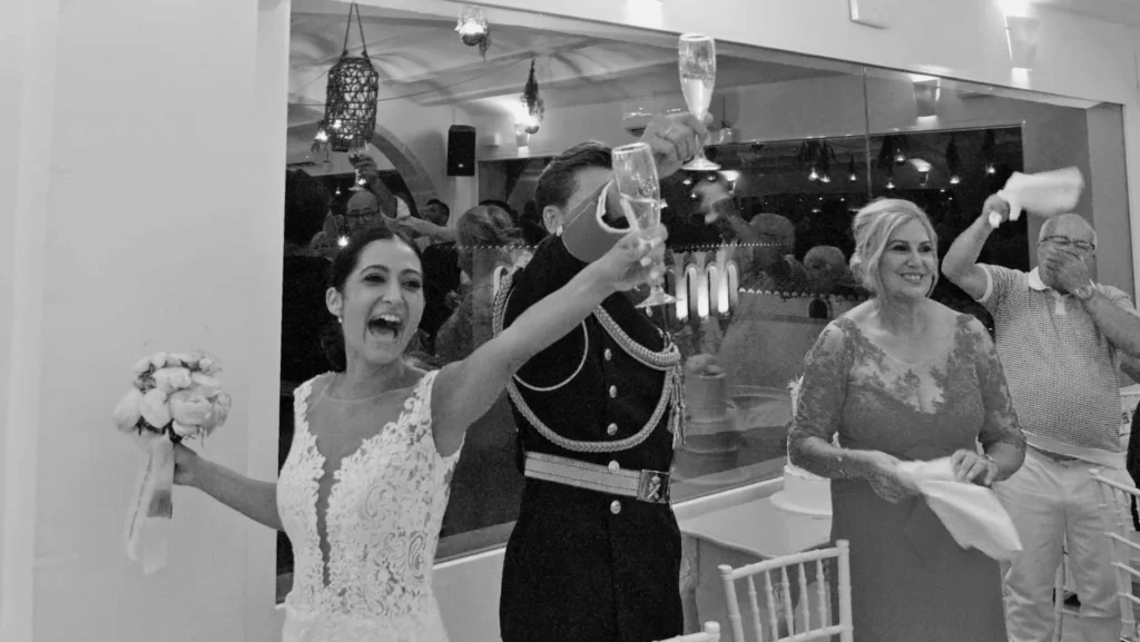 Champagne toast and big smiles — elegant reception moment.