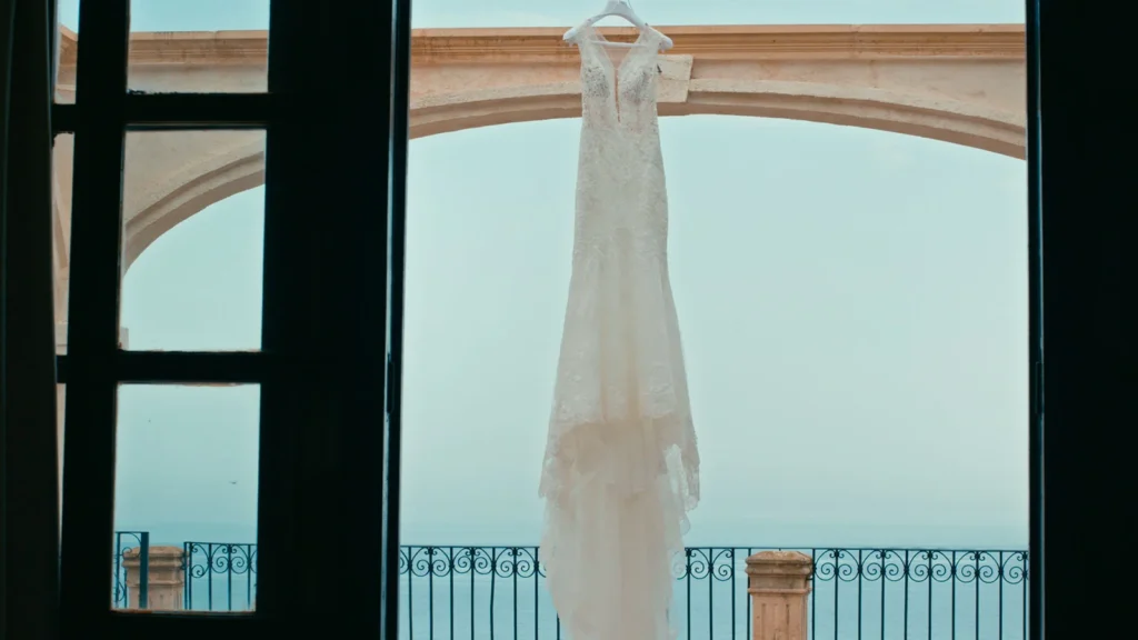 The wedding dress hangs in front of a stunning ocean backdrop in Florida.